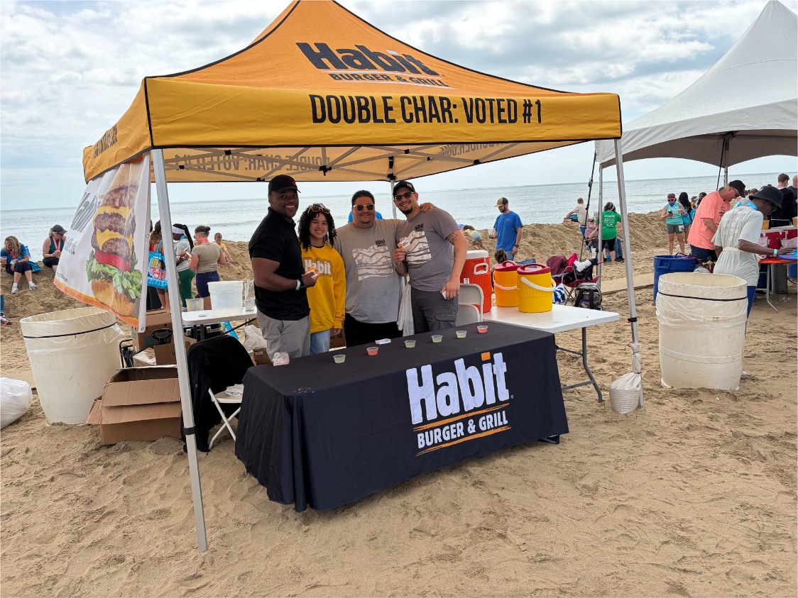 Branded Habit Burger tent with team at beach race